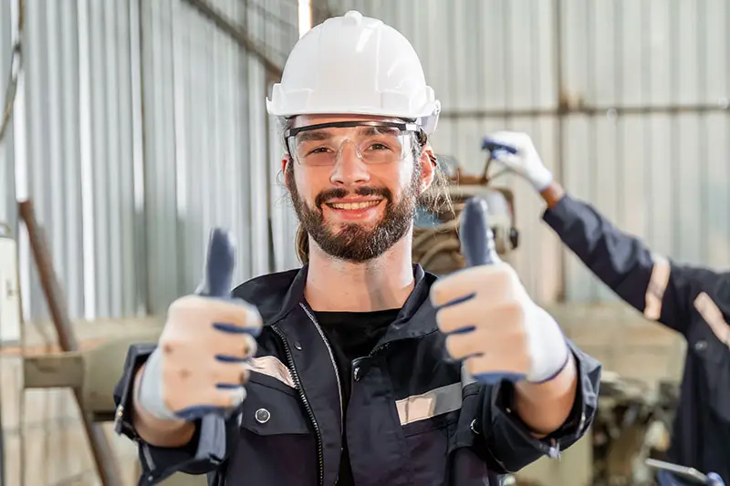 Technician with 2 thumbs up for paint drying equipment that requires low maintenance | Sun-Spot