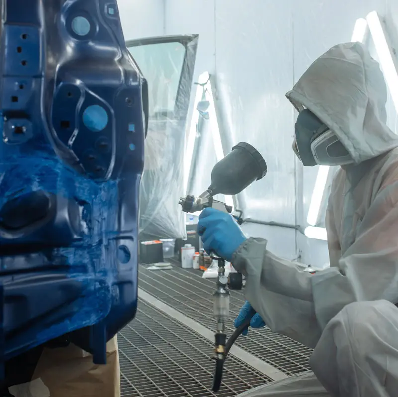 Paint shop owners at work spraying | Sun-Spot