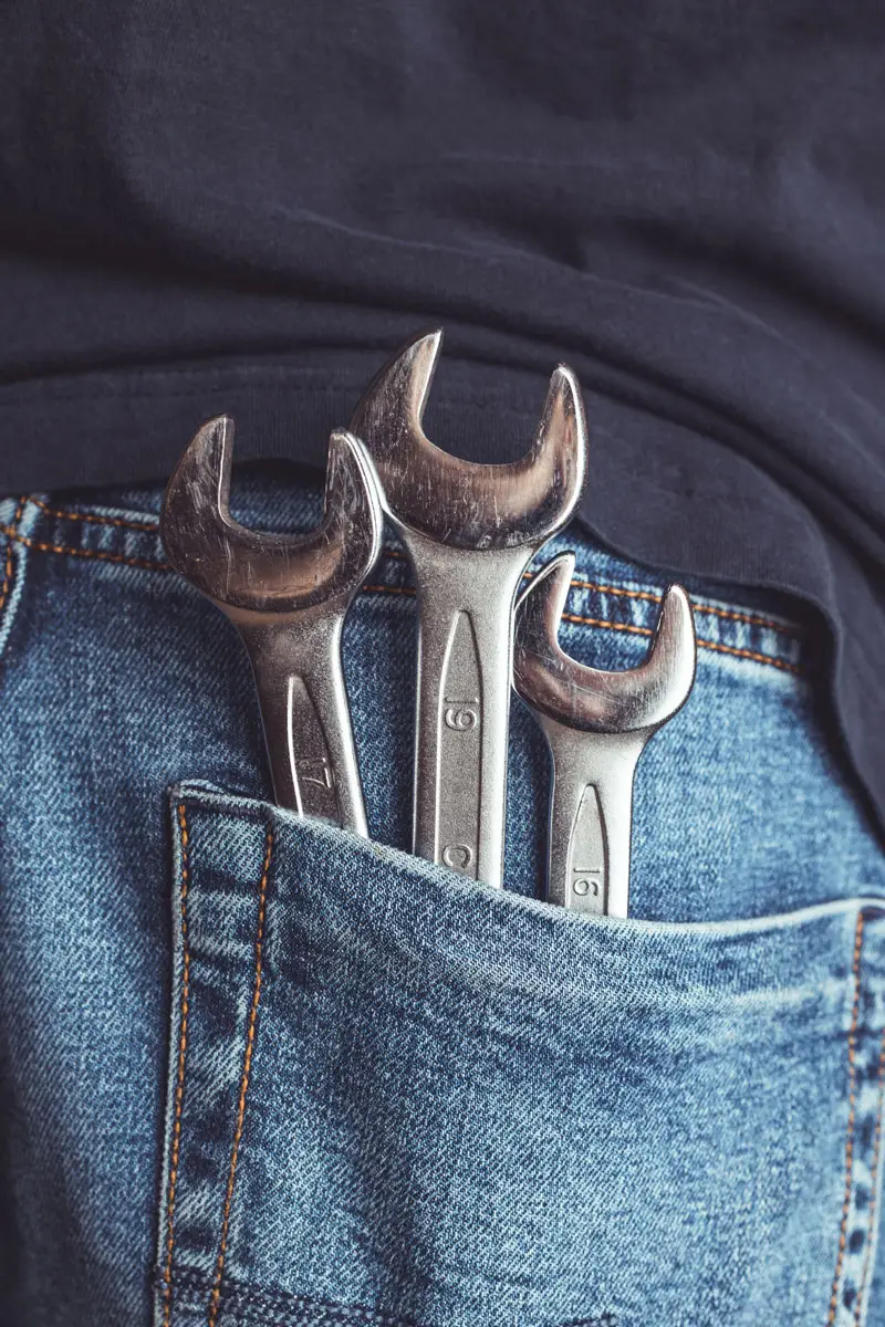 maintenance employee with tools in pocket working for Green Business Certification company | Sun-Spot
